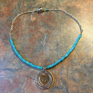 Silvertone And Turquoise Colored Bead Religious Pendant Necklace